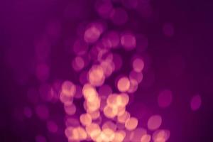 Dark purple Festive Christmas Beautiful abstract Background with bokeh lights. Holiday Texture with copy space. Can be used as Wallpaper, filling for a website, defocused photo