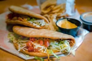 Tacos with Mango Salsa and Chips.Mixed mexican food Guacamole, nachos, fajita, meat tacos. Top view. Tex mex cuisine. photo