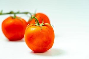 tometoes isolate on white background. bunch the red tometos isolated in white background its fresh nutritious and citrious photo