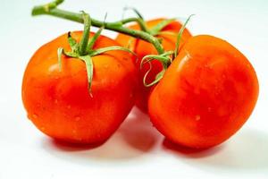 tometoes isolate on white background. bunch the red tometos isolated in white background its fresh nutritious and citrious photo