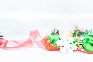 Christmas of  winter - Christmas balls with ribbon on snow, Winter holidays concept. Christmas green balls, golden balls, pine And Snowflakes decorations In Snow Background photo