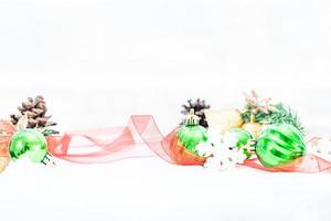 Christmas of  winter - Christmas balls with ribbon on snow, Winter holidays concept. Christmas green balls, golden balls, pine And Snowflakes decorations In Snow Background photo