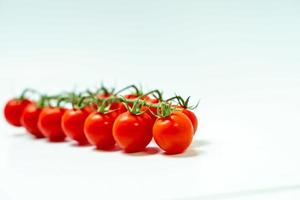 tometoes isolate on white background. bunch the red tometos isolated in white background its fresh nutritious and citrious photo