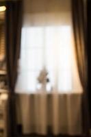 Abstract and blurry image of window with curtains with fir tree photo