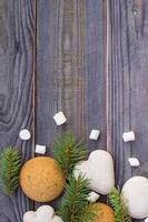 Christmas border with gingerbread, marshmallow and branch of fir tree photo