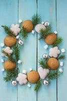 Christmas wooden background with tree branches, gingerbread and marshmallows photo