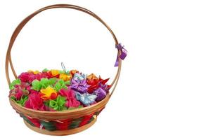 Fold the colorful mulberry paper or ribbon and put the coin inside in basket for donate in buddhism of Thailand isolated on white background. photo