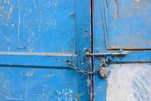 Old latch on a wooden blue door photo