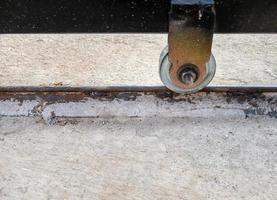 The metal wheels of the sliding door on the rail. photo