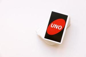 TERNOPIL, UKRAINE - MAY 15, 2022 Many colorful UNO game cards on white background. UNO is an American shedding-type card game that is played with a specially printed deck photo