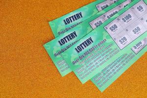 Close up view of green lottery scratch cards. Many used fake instant lottery tickets with gambling results. Gambling addiction photo