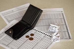 Crumpled lottery tickets and empty purse as symbol of losing the lottery game. Unlucky gambling results. Misfortune photo