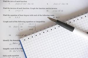 Handwriting of mathematics quadratic equation on examination, practice, quiz or test in maths class. Solving exponential equations concept. photo