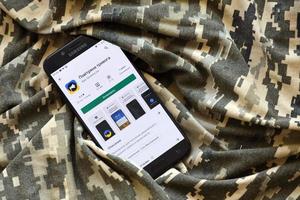 TERNOPIL, UKRAINE - APRIL 24, 2022 Air Raid Siren app for mobile phone on smartphone display screen on the military camouflage photo