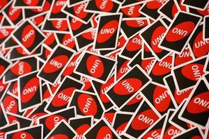 TERNOPIL, UKRAINE - MAY 15, 2022 Many colorful UNO game cards. UNO is an American shedding-type card game that is played with a specially printed deck photo