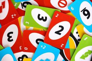 TERNOPIL, UKRAINE - MAY 15, 2022 Many colorful UNO game cards. UNO is an American shedding-type card game that is played with a specially printed deck photo