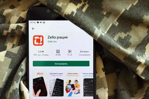 TERNOPIL, UKRAINE - APRIL 24, 2022 Zello Walkie Talkie mobile app logo from Play Market on phone screen close up on ukrainian military camouflage photo