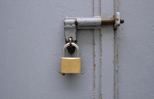 Metal padlock on a metal gate photo