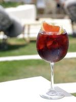 Glass of fresh Sangria with ice on a sunny day photo