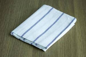 folded napkin on wooden table photo