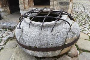 ancient round stone well photo