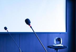 Microphone on table with projector screen background in meeting room photo