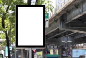 Outdoor pole billboard with mock up white screen on footpath and clipping path photo