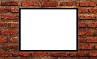 Mockup white picture frame on orange brick wall background with clipping path photo