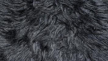 Black wool rug texture background photo