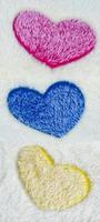 Wool rug texture with colorful heart pattern background photo