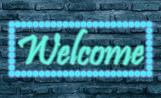 Message Welcome with effect neon light on black brickwall photo