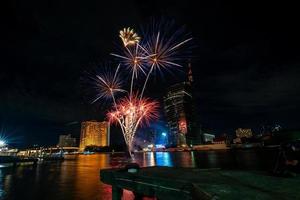 fireworks on the river in the dark sky photo