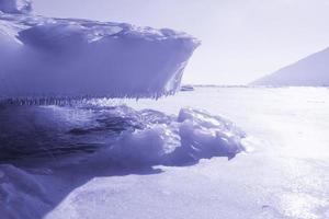 Lake Baikal. ice rocks, sculptures, transparent ice near the sandy bay. beauty of russia photo