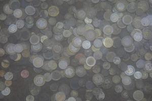 coins tossed into the wishing pond photo