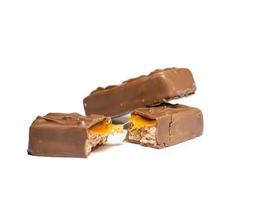 Broken chocolate bar on a white background. Slices of chocolate. photo