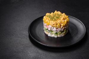 Fresh vegetable salad with corn, pepper, crab, cucumber, eggs and mayonnaise photo