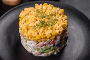 Fresh vegetable salad with corn, pepper, crab, cucumber, eggs and mayonnaise photo