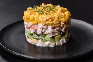 Fresh vegetable salad with corn, pepper, crab, cucumber, eggs and mayonnaise photo