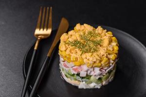 Fresh vegetable salad with corn, pepper, crab, cucumber, eggs and mayonnaise photo