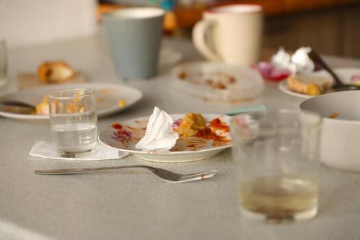 Empty dirty plates with spoons and forks on the table after meal. Banquet ending concept. Unwashed dishes photo