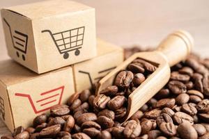 Box with shopping cart logo symbol on coffee beans, Import Export Shopping online or eCommerce delivery service store product shipping, trade, supplier concept. photo