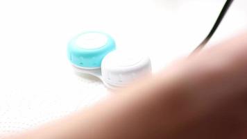 les mains des hommes passant des lunettes aux lentilles de contact avec des soins hygiéniques en les sortant de la boîte pour corriger la vision comme la myopie ou l'hypermétropie par des lunettes d'optométrie pour une vue claire video