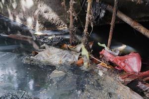 selectively focus on garbage stuck in ditches, which can clog and cause flooding photo