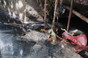 selectively focus on garbage stuck in ditches, which can clog and cause flooding photo