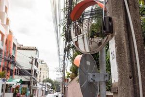 Convex mirror on pole on public road, Round Security Mirror for safety of entrances and exits or curves that are difficult to see, Road traffic safety concept photo