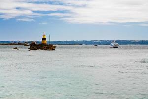 lighthouses at the rock in sea photo