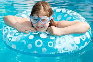 girl in swim goggle on swimming circle photo