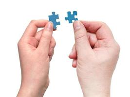 male and female hands with little puzzle pieces photo