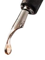 drop of transparent fluid on nib of pen photo