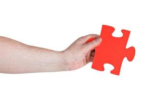 male hand holding big red paper puzzle piece photo